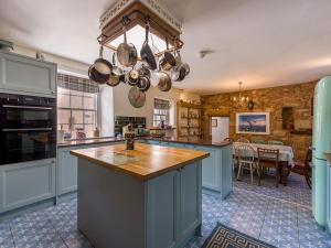 a kitchen with a large island in the middle at Lickleyhead Castle in Insch