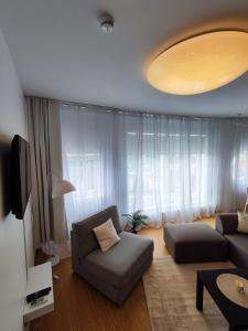 a living room with a couch and a large window at Wilde Guest Apartment Tigutorn in Tartu