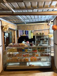a bakery display case with different types of food at FARILA LODGE in Kelimutu +87 photos
