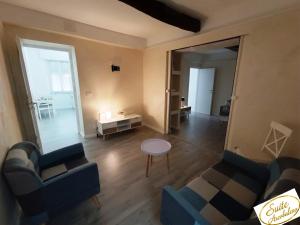 a living room with two couches and a table at Suite Arcobaleno in Deiva Marina