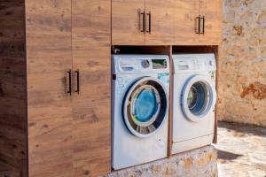 a washing machine sitting inside of a cabinet at Istlada Taş Ev Apart - Kekova Island View in Demre