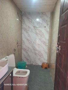 a bathroom with a toilet and a sink at Auli haven in Joshīmath
