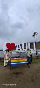 a group of people standing around a bench with a heart at Auli haven in Joshīmath