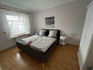 a bedroom with a bed with a black bed frame at Ferienwohnungen Camping SPO OHG in Böhl