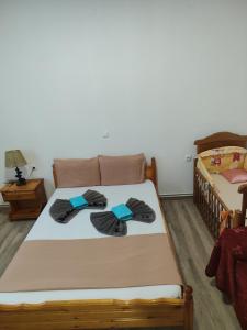 a bedroom with two beds with towels on them at Xaris House in Ávaton