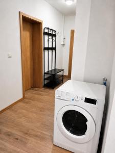 a white washing machine in a room with a door at Monteurwohnungen in Markranstädt in Markranstädt