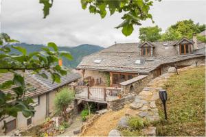 a house on a hill with a balcony at The Dragon Barn - Grenier in Ascou