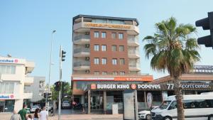 a building on the corner of a busy city street at Hiper Suites Residance in Antalya