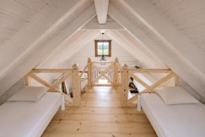 a room with two beds in a attic at KOPUVA seaside villas in Nida
