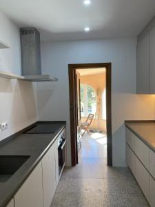 a kitchen with white counters and a door into a room at Casa Luis - Javea - Spanien in Jávea +37 photos