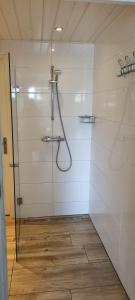 a bathroom with a shower with a glass door at 't Achterhuis in Alteveer
