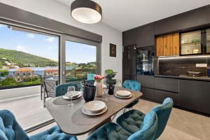 a kitchen and dining room with a table and chairs at Alba Azzura in Zaton