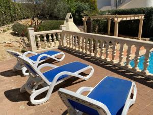 two blue and white lounge chairs next to a pool at Casa Luis - Javea - Spanien in Jávea