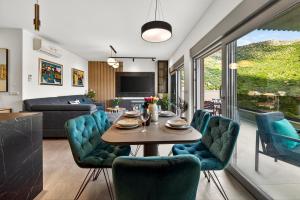 a dining room and living room with a table and chairs at Alba Azzura in Zaton