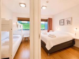 a bedroom with a bunk bed and a desk at Central Apartment in Geilo in Geilo