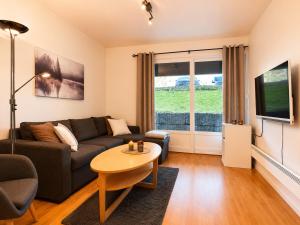 a living room with a couch and a table at Central Apartment in Geilo in Geilo