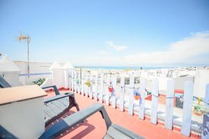 a balcony with white fences and a view of the ocean at Casa Edison in Conil de la Frontera