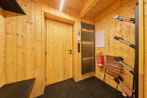 a wooden cabin with a bench and a fire extinguisher at Glamping KOLBENKA in Horní Malá Úpa +16 photos