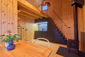 a dining room with a table and a staircase at Glamping KOLBENKA in Horní Malá Úpa