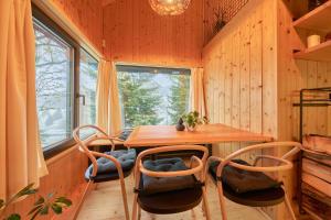 a dining room with a table and chairs and a window at Glamping KOLBENKA in Horní Malá Úpa