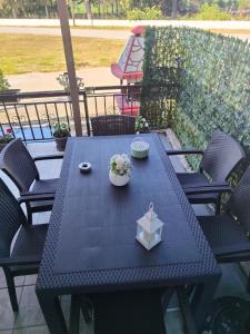 a blue table with flowers and a box on a patio at Xaris House in Ávaton