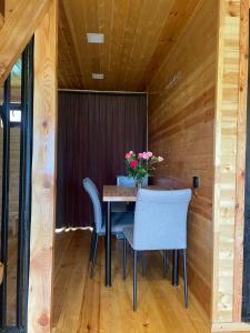 a dining room with a table and chairs at Sunset Cottage Busheti in Busheti