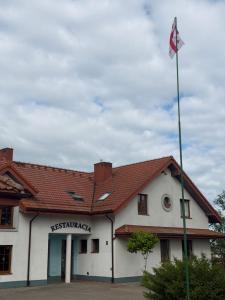 a building with a flag in front of it at Apartamenty u Gruzina in Ruda
