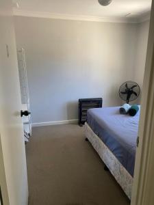 a bedroom with a bed in a room at Girrawheen3 - Room in a Shared House in Perth +5 photos