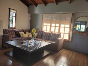 a living room with a couch and a table at BAHIA BLANCA-BARRIO PARQUE in Bahía Blanca
