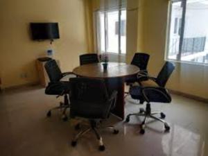 a conference room with a table and chairs at abuzz oc shimla in Shimla