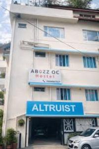 an apartment building with a sign for an air trust at abuzz oc shimla in Shimla