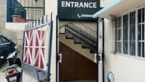 an entrance to a building with a staircase in front at abuzz oc shimla in Shimla