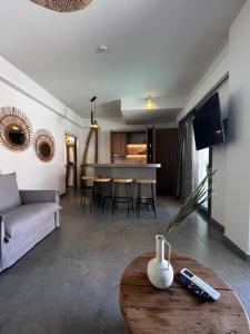 a living room with a couch and a table at Olvion Luxury Living in Kallithea Halkidikis