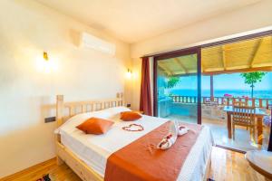 a bedroom with a bed with a view of the ocean at Istlada Taş Ev Apart - Kekova Island View in Demre