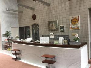 a counter with two stools in front of a store at Utsunomiya Inter Resort Hotel & Golf Tsuru Country Club in Utsunomiya +9 photos