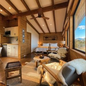 a bedroom with a bed and a large window at Volcano Suites in Puyehue +14 photos