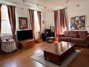 a living room with a couch and a coffee table at The Old Vic Hotel in Canowindra
