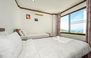 a bedroom with two beds and a large window at Skyline Seaview Villa-5 Bedroom, 4 Bathrooms with Private Seaview Pool in Ban Thong Phlu +33 photos