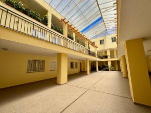 an empty hallway of an apartment building with a skylight at Cantinho de Santa Teresa in Canhas