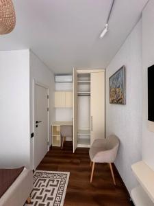 a living room with a couch and a chair in a room at Vatra Dumeniului in Vorniceni