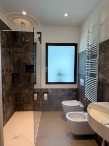 a bathroom with a toilet and a shower with a window at Bastian B&B in Sarmede +19 photos