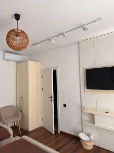 a living room with a flat screen tv and a couch at Vatra Dumeniului in Vorniceni +45 photos
