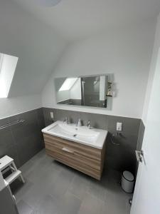 a bathroom with a sink and a mirror at Wangerbrise in Wangerland +11 photos