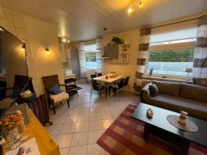 a living room with a couch and a table at Bluhm EG in Wangerland