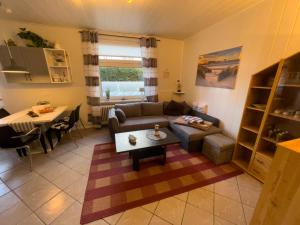 a living room with a couch and a table at Bluhm EG in Wangerland +9 photos