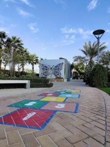 a painting of a butterfly on a sidewalk at Bahrain Bay Retreat Studio in Manama +13 photos