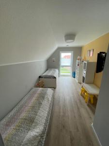 a room with two beds and a window at Wangerstrand in Wangerland