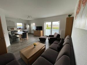a living room with a couch and a table at Am Wangermeer 38 in Wangerland