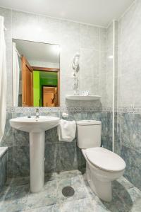 a bathroom with a toilet and a sink at Pension Monteverde in Cangas de Onís +15 photos