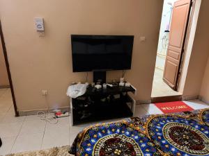 a living room with a flat screen tv on the wall at Fitini appart in Bamako +2 photos